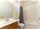 Bathroom with a single sink vanity and white tiled shower and tub combo at 9986 Sand Key St, Las Vegas, NV 89178