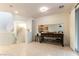 Bright living room with tile flooring, view of kitchen, and stairway to the upper level at 9986 Sand Key St, Las Vegas, NV 89178