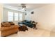 Comfortable living room with a ceiling fan, tile floors, and a view of the windows at 9986 Sand Key St, Las Vegas, NV 89178