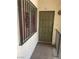 A welcoming olive-green front door with security bars on the adjacent window invites you into your new home at , Las Vegas, NV 89115