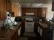 The kitchen features wooden cabinets and is equipped with essential appliances for convenient meal preparation at , Las Vegas, NV 89115
