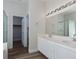 Bathroom featuring double sinks with a large well-lit mirror and a glass shower door at 10075 Yellow Canary Ave, Las Vegas, NV 89117