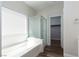 Bright bathroom showcasing a shower over tub with glass doors and a walk-in closet at 10075 Yellow Canary Ave, Las Vegas, NV 89117