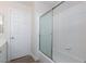 Well-lit bathroom with tiled shower and glass doors at 10075 Yellow Canary Ave, Las Vegas, NV 89117