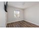 Cozy bedroom features wood-look floors and a bright window at 10075 Yellow Canary Ave, Las Vegas, NV 89117