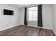 Bedroom featuring hardwood floors, a large window, and neutral paint at 10075 Yellow Canary Ave, Las Vegas, NV 89117