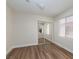 Cozy bedroom with a mirrored closet and hardwood floors, well-lit by a window at 10075 Yellow Canary Ave, Las Vegas, NV 89117