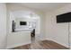 Additional bedroom featuring hardwood floors and an open archway into the main bedroom at 10075 Yellow Canary Ave, Las Vegas, NV 89117