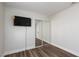 Bedroom featuring hardwood floors, closet with sliding doors, and fresh neutral paint at 10075 Yellow Canary Ave, Las Vegas, NV 89117