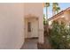 Entryway with covered porch, neutral stucco, and low-maintenance landscaping at 10075 Yellow Canary Ave, Las Vegas, NV 89117