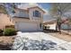 Two-story home featuring a red tile roof, white stucco, concrete driveway and low maintenance desert landscaping at 10075 Yellow Canary Ave, Las Vegas, NV 89117