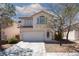 Two-story home featuring a red tile roof, white stucco, concrete driveway and low maintenance desert landscaping at 10075 Yellow Canary Ave, Las Vegas, NV 89117