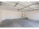 A spacious two car garage with an automatic door, water heater, and ample room for storage at 10075 Yellow Canary Ave, Las Vegas, NV 89117
