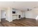 Spacious living room featuring a modern fireplace, ceiling fan, and hardwood-style flooring at 10075 Yellow Canary Ave, Las Vegas, NV 89117
