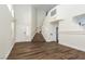 Spacious living room boasts wood flooring, tall ceilings, large windows, and stairs to the second story at 10075 Yellow Canary Ave, Las Vegas, NV 89117