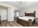 Bright main bedroom featuring hardwood floors, a ceiling fan, and a walk-in closet at 10075 Yellow Canary Ave, Las Vegas, NV 89117