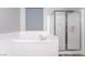 Bright bathroom featuring a soaking tub and glass-enclosed shower at 10259 Wolves Den Ln, Las Vegas, NV 89178