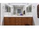 Bathroom with double vanity, wood cabinets, and large mirror at 10259 Wolves Den Ln, Las Vegas, NV 89178
