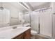 Clean bathroom with a large vanity, framed mirror, and glass enclosed shower at 10259 Wolves Den Ln, Las Vegas, NV 89178