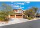 Charming two-story home with a three-car garage, desert landscaping and neutral paint at 10259 Wolves Den Ln, Las Vegas, NV 89178