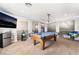 Bright game room with a pool table, mounted projector and television at 10259 Wolves Den Ln, Las Vegas, NV 89178