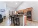 Kitchen featuring stainless steel appliances, tile floors, breakfast bar and wooden cabinetry at 10259 Wolves Den Ln, Las Vegas, NV 89178