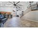 Open-concept floorplan, high ceilings, tiled floors, connecting the living room and kitchen at 10259 Wolves Den Ln, Las Vegas, NV 89178
