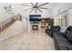 Spacious living room with tiled floors, fireplace, high ceilings and a staircase to the second floor at 10259 Wolves Den Ln, Las Vegas, NV 89178