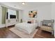 Bright bedroom features a bed, grey baby crib, neutral rug, and colorful abstract art at 1121 Via Castelli, Henderson, NV 89052