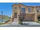 Charming two-story townhome featuring a balcony, two-car garage, and landscaped front yard at 1121 Via Castelli, Henderson, NV 89052