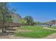 Beautifully landscaped front yard with lush green grass, desert landscaping, and mature trees at 1121 Via Castelli, Henderson, NV 89052