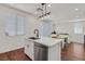 Open kitchen featuring an island with a sink, stainless steel dishwasher, and a dining area at 1121 Via Castelli, Henderson, NV 89052