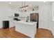 Modern kitchen featuring stainless steel appliances, a center island, and ample cabinet space at 1121 Via Castelli, Henderson, NV 89052