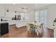 Bright kitchen with stainless steel appliances, center island, adjacent dining area, and wood flooring at 1121 Via Castelli, Henderson, NV 89052