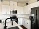 Modern kitchen featuring white cabinets, stainless steel appliances, and marble backsplash at 1121 Via Castelli, Henderson, NV 89052