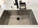 Detailed view of a stainless steel kitchen sink and white countertop at 1121 Via Castelli, Henderson, NV 89052