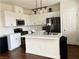 Modern kitchen with white cabinets, stainless steel appliances, and a center island at 1121 Via Castelli, Henderson, NV 89052