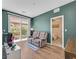 Nicely staged living room featuring stylish furniture, a sliding glass door, and soothing wall color at 1121 Via Castelli, Henderson, NV 89052