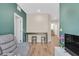Open living room with hardwood floors and green walls at 1121 Via Castelli, Henderson, NV 89052
