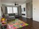 Bright living room with dark wood floors, fireplace, and large windows providing ample natural light at 1121 Via Castelli, Henderson, NV 89052