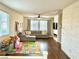 Bright living room featuring large windows, a gray sectional, and modern decor at 1121 Via Castelli, Henderson, NV 89052