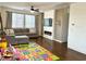 Bright living room with dark wood floors, fireplace, and large windows providing ample natural light at 1121 Via Castelli, Henderson, NV 89052