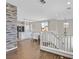 Open-concept living space that connects kitchen and living room featuring a statement brick accent wall at 1121 Via Castelli, Henderson, NV 89052