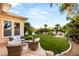 Beautiful backyard featuring lush landscaping, manicured lawn, and outdoor seating areas at 1200 Dry Point Ct, Las Vegas, NV 89144