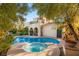 Exterior of a two-story home with pool, jacuzzi, and landscaping in the backyard at 1200 Dry Point Ct, Las Vegas, NV 89144