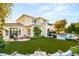 Beautiful backyard featuring a pool, luscious lawn, and back patio with seating areas at 1200 Dry Point Ct, Las Vegas, NV 89144