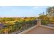 A balcony with iron railings offers stunning panoramic views of lush greenery and city skyline at 1200 Dry Point Ct, Las Vegas, NV 89144