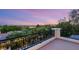 Enjoy the colorful sunset with city views from this home's balcony, featuring black wrought iron railings at 1200 Dry Point Ct, Las Vegas, NV 89144