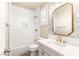Bright bathroom featuring neutral tile, white vanity with gold fixtures, and a shower-tub combination at 1200 Dry Point Ct, Las Vegas, NV 89144