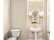 Powder room featuring hexagonal tile accent wall, pedestal sink, and gold fixtures at 1200 Dry Point Ct, Las Vegas, NV 89144